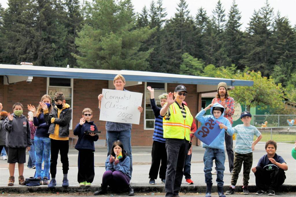 Children and faculty members standing outside of South Whidbey Elementary School cheered as the parade of high school seniors passed by them. (Photo by Kira Erickson/South Whidbey Record)