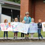 Children and faculty members standing outside of South Whidbey Elementary School cheered as the parade of high school seniors passed by them. (Photo by Kira Erickson/South Whidbey Record)