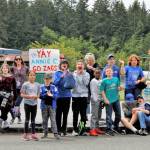 Children and faculty members standing outside of South Whidbey Elementary School cheered as the parade of high school seniors passed by them. (Photo by Kira Erickson/South Whidbey Record)