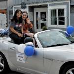 Natalie Monetti and Tess Patty-Caldwell wave from the backseat of a car driven in the parade Wednesday afternoon. (Photo by Kira Erickson/South Whidbey Record)