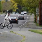 A woman bikes through an intersection in Oak Harbor. (Photo by Karina Andrew/Whidbey News-Times)