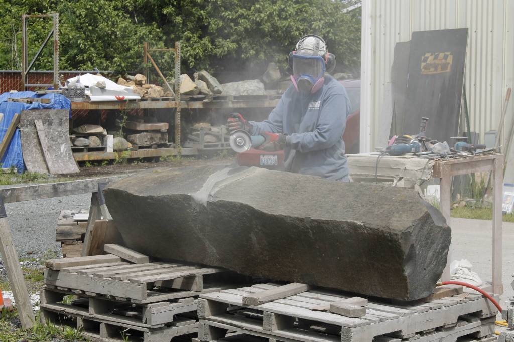 Photo by Kira Erickson/South Whidbey Record
Sue Taves carves an enormous chunk of basalt.