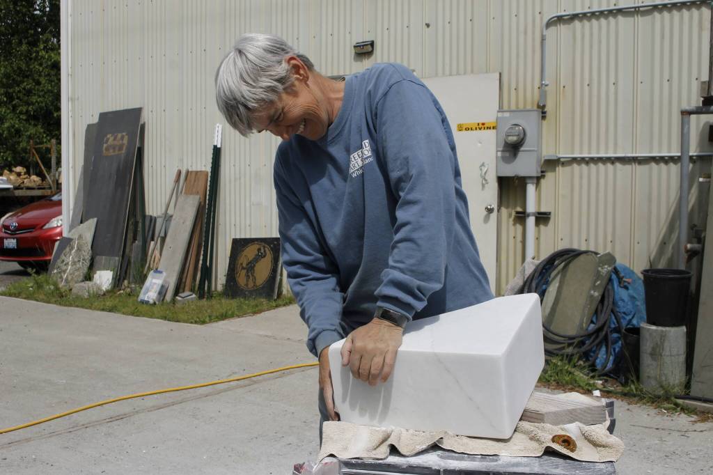 Photo by Kira Erickson/South Whidbey Record
Sue Taves sands a block of marble.