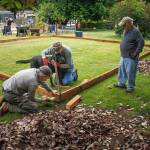 Photos by David Welton
From left to right, Jan-Marc Jouas, Russ DeWolfe and David LaBreque of Rotary Club of South Whidbey Island, with assistance from service dog Theo, work on building an enclosure for a playground in the backyard of the House of Hope.