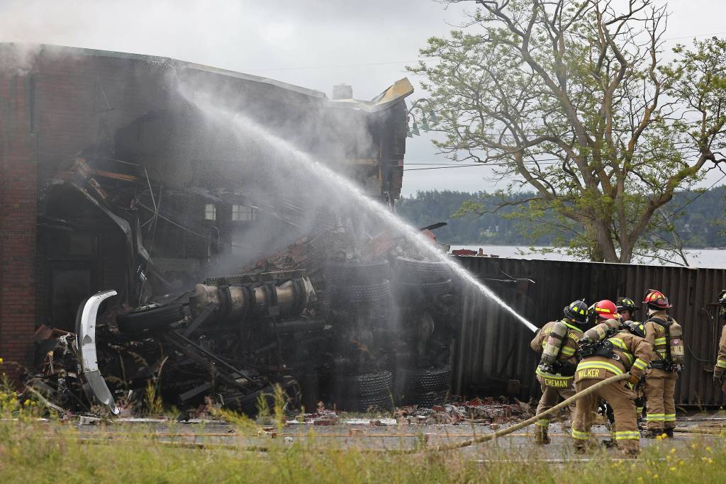 Photo by John Fisken
Firefighters finish off the fire at Penn Cove Pottery Sunday morning.