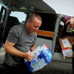 Bryan Painter unload his plane. (Photo By David Welton)