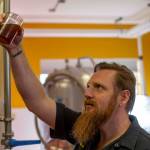 Erick Adam of Penn Cove Brewing inspecting beer. (Photo provided by Penn Cove Brewing).