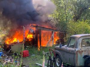 A storage shed and travel trailer were completely destroyed in a fire June 25. (Photo by South Whidbey Fire/EMS)