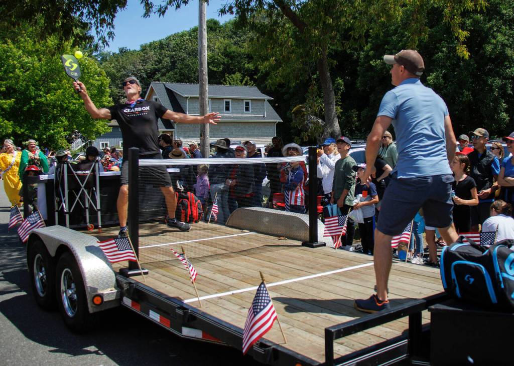 Bob Bowling returns a serve on the traveling pickleball court that was part of the Maxwelton parade.