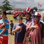 Maxwelton parade-goers pause for the National Anthem.