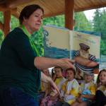Library employee Jayanne Bixby reads a story at Family Story Time at Castle Park July 6. (Photo by David Welton)