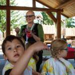 Library employee Tracy Miller blows bubbles for children at Family Story Time at Castle Park on Wednesday. (Photo by David Welton)