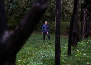 Earth Sanctuary owner Chuck Pettis next to his Ley Line piece on Tuesday, Oct. 20, 2020 in Langley, Wa. (Olivia Vanni / The Herald)