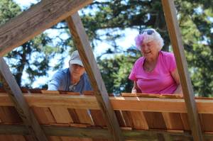 Volunteers build a roof in the style of the early 1900s on the Pratt Machine Shed in Ebeys Landing National Historical Reserve. (Photo by Karina Andrew/Whidbey News-Times)