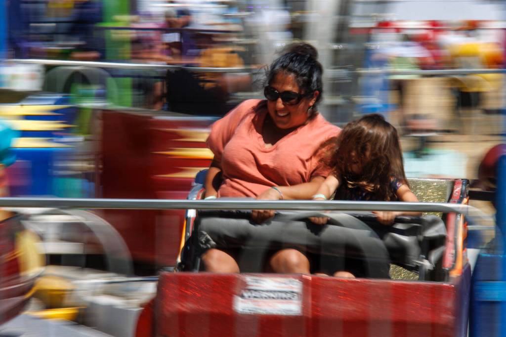 Fairgoers enjoy a dizzying carnival ride Thursday afternoon.