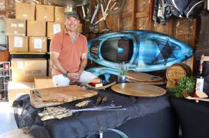 Bill Leuthe repurposes wine barrels to create serving trays, cutting boards and furniture. He will be selling his products at the Coupeville Arts and Crafts Festival for the first time this year. (Photo by Karina Andrew/Whidbey News-Times)