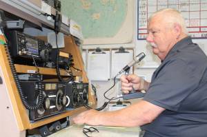 Terry Sparks uses the high-frequency radio at the NAS Whidbey Island Military Auxiliary Radio Service Station. (Photo by Karina Andrew/Whidbey News-Times)
