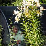 Melinda Creed waters the many plants she cares for at Moonstruck Gardens.