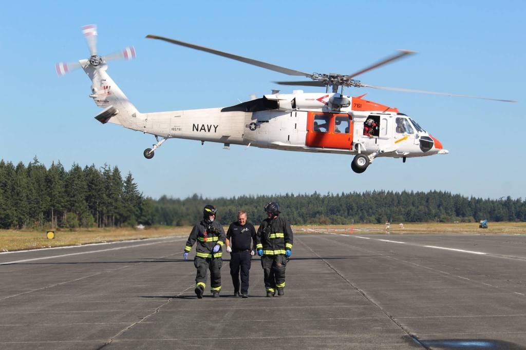 A Navy Search and Rescue helicopter takes off with two Navy personnel simulating critically wounded patients in a training Wednesday morning.