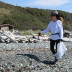 Volunteer Deb Savalza helps clean up a Central Whidbey beach on Aug. 30.