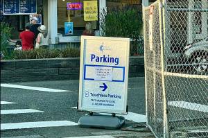 This Tuesday photo shows a sign by the Mukilteo waterfront parking lot that says the lot opens Sept. 2, however the lots opening has been delayed. (Andrea Brown / The Herald)