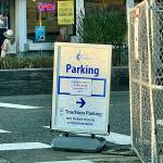 This Tuesday photo shows a sign by the Mukilteo waterfront parking lot that says the lot opens Sept. 2, however the lot’s opening has been delayed. (Andrea Brown / The Herald)