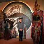 Photos by David Welton
Jerry Wennstrom in front of a luminous mural of a mountain lion and Native American figures that he painted in his gallery.
