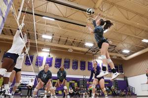 Photo by John Fisken
Sophomore Karen Salinger hits the ball in a match against Ferndale. From left, her teammates, senior Paige Fortin, sophomore Jiana Alcaraz-Carter, and senior Mia Carman support the play.