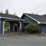 File photo
Officials from the Whidbey Homeless Coalition stand in front of the former Jehovahs Witness Church in Central Whidbey that is being turned into a emergency homeless shelter.