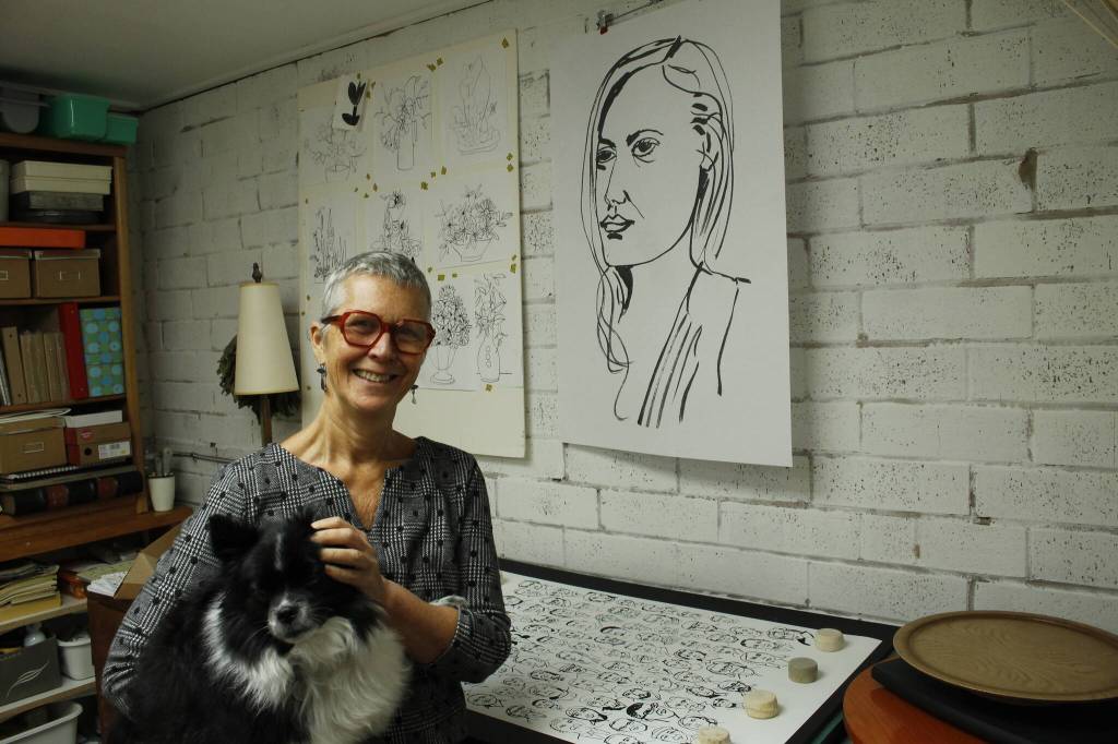 Photo by Kira Erickson/South Whidbey Record
Meredith MacLeod, photographed here with Mika, is the illustrator behind Cast of Characters.