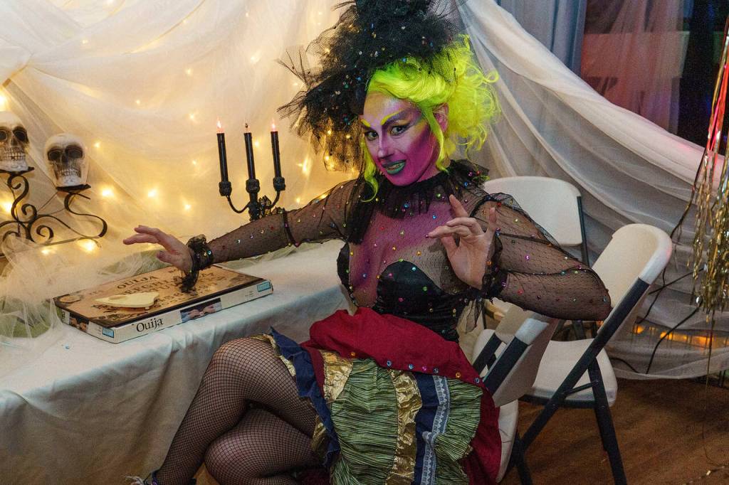 Jade Logan, a Freeland resident, poses near an Ouija board.