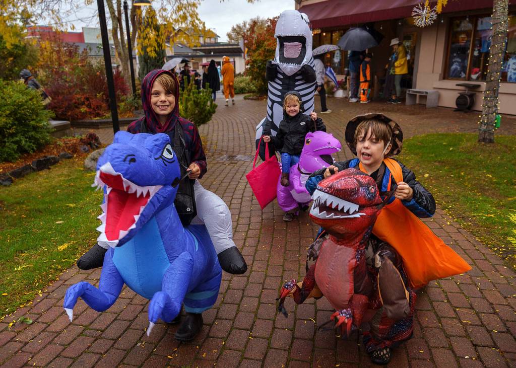 A family of dinosaurs participates in Spooktacular Langley on Halloween.