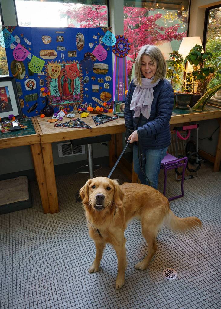 Photo by David Welton
Heidi Dudley and her dog Jupider celebrate Dia de los Muertos at Georgia Edwards home in Clinton. Edwards builds an altar to honor deceased pets every year.