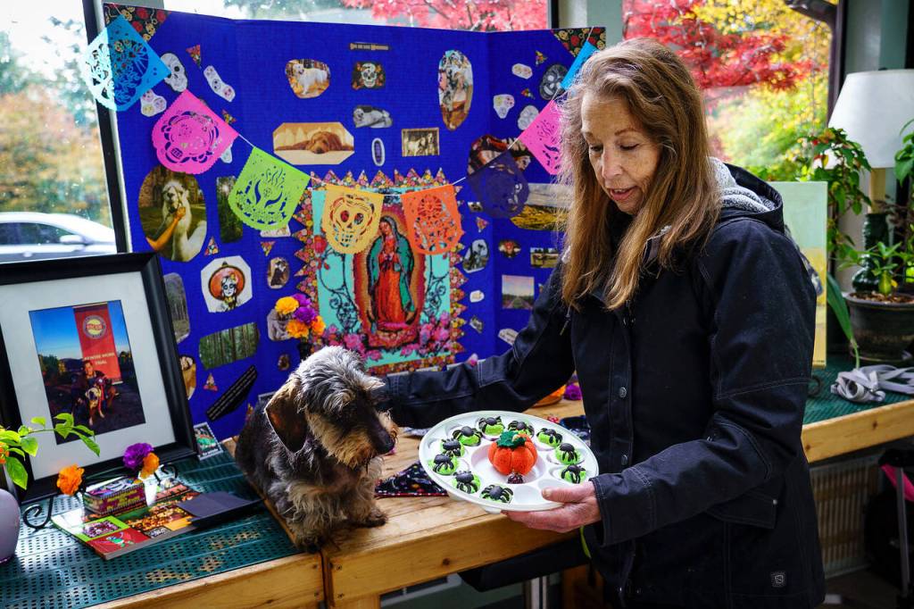 Photo by David Welton
Maryl Douglas and her dog Daffodil celebrate Dia de los Muertos at Georgia Edwards home in Clinton. Edwards builds an altar to honor deceased pets every year.