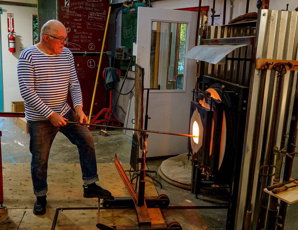 Photos by David Welton
John de Wit readies a piece of glass in the furnace.