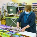 File photo/South Whidbey Record
Luanne Seymour, photographed here in 2021, shows a few different-sized quilts that Whidbey Blanket Makers sewed. The group continues to meet at Create Space.