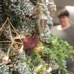 Grayson Akins, a match coordinator for Big Brothers Big Sisters of Island County, decorates a tree for auction at the Festival of Trees.