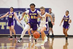 Photo by John Fisken
From left, Oak Harbor basketball players Zoe Scott and Annalise Wesley chase the ball during a scrimmage at Night Out with the Cats Saturday.