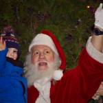 Photo by Rachel Rosen/Whidbey News-Times
Elwah Kirn, at left, broke away from the crowd to give Santa a hug after the Oak Harbor Christmas parade Saturday.