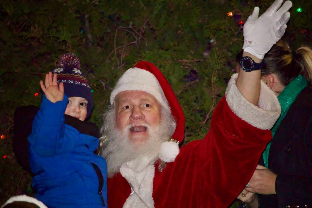 Photo by Rachel Rosen/Whidbey News-Times
Elwah Kirn, at left, broke away from the crowd to give Santa a hug after the Oak Harbor Christmas parade Saturday.