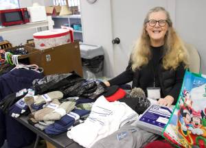 Photo by Rachel Rosen/Whidbey News-Times
Garage of Blessings volunteer Jane Brent organized one of the nonprofits holiday events this year. She handed out brand new scarves, hats, gloves and other clothing needed for winter.