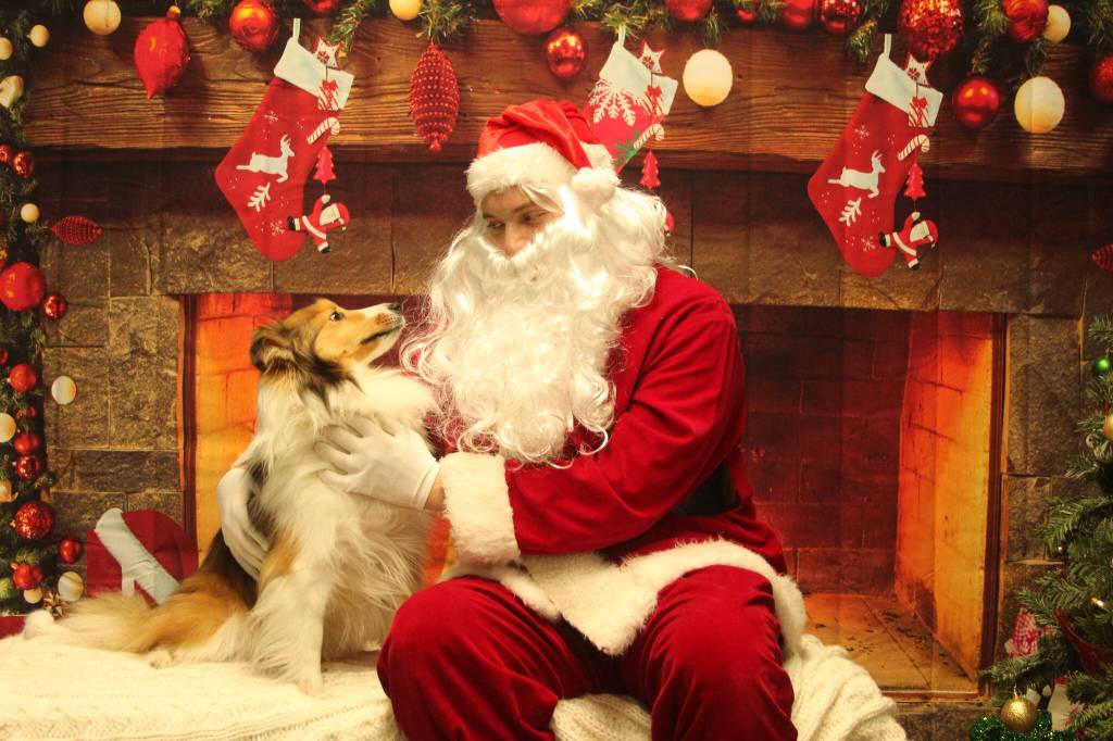 Photo by Karina Andrew/Whidbey News-Times
Claire nabs a spot on the nice list while posing for a photo with Santa Claus.