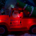 An inflatable Santa Claus makes a Christmas tree delivery. (Photo by David Welton)