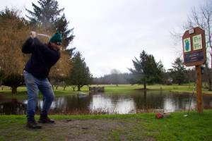 Photo by Rachel Rosen/Whidbey News-Times
Ian Kenney, who owns Deception Pass Golf Center with his father Don, tees off at the courses most picturesque hole.