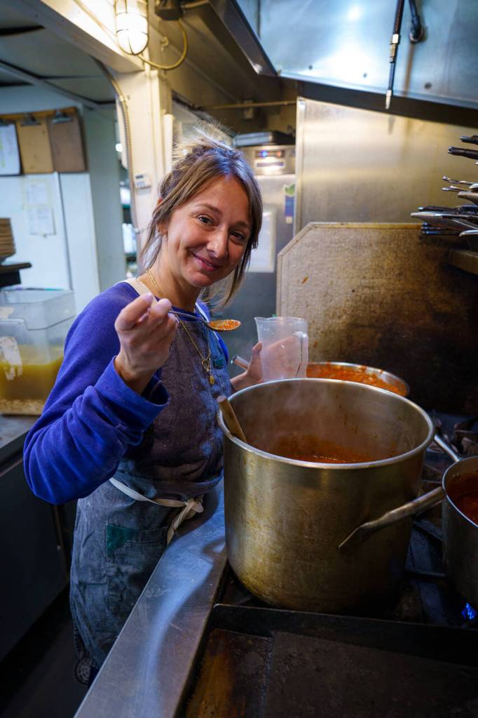 Courtney Storer taste tests a sauce. (Photo by David Welton)