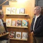 Meg Olson, left, tells Rep. Rick Larsen about the troubles her shop, Kingfisher Bookstore, encountered during the last king tide. (Photo by Karina Andrew/Whidbey News-Times)