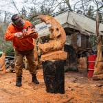 Olivia Vanni / The Herald
Steve Backus works on the details of a moon carving at his outdoor workshop in Clinton. A Dec. 2 fire destroyed his studio in the former sawmill on the 4-acre Glendale Road property that houses his Big Shot Woodcarving business and home.