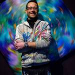 Photo by David Welton
Cormac McCarthy stands before an interactive, spinning piece of artwork known as Ballet of the Koi No. 3.
