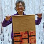 Photos by David Welton
Laura Stangel Schmidt with Interior Monologue, an art quilt interspersed with brown paper bags.
