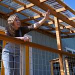 Gabbi Korrow waves to a friend from the front porch of her home. (Photo by David Welton)